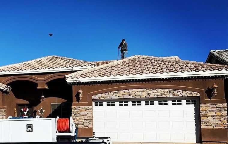 Tech on top of a residential homes roof